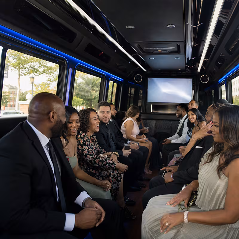 Wedding guests seated inside a Newark party bus