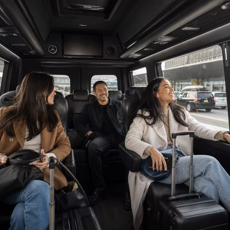 Passengers loading luggage while boarding an Newark group shuttle