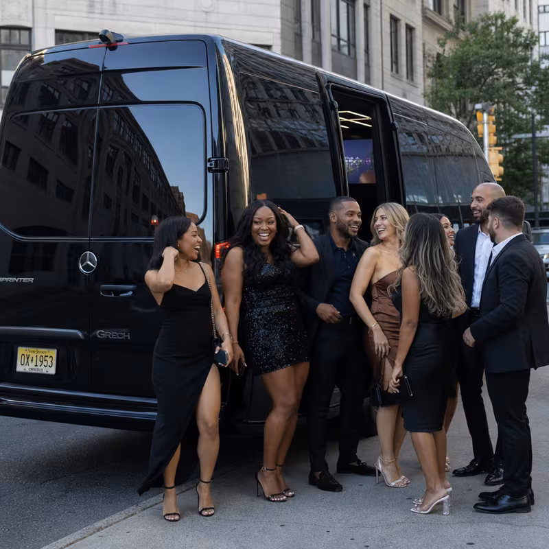 Group boarding a white charter bus for Bachelor & Bachelorette Transportation transportation in Newark