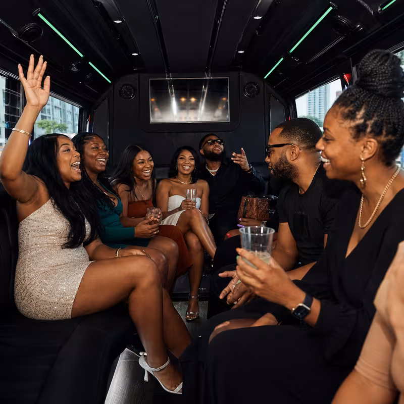 Party bus interior with wraparound leather seating and LED lighting in Newark