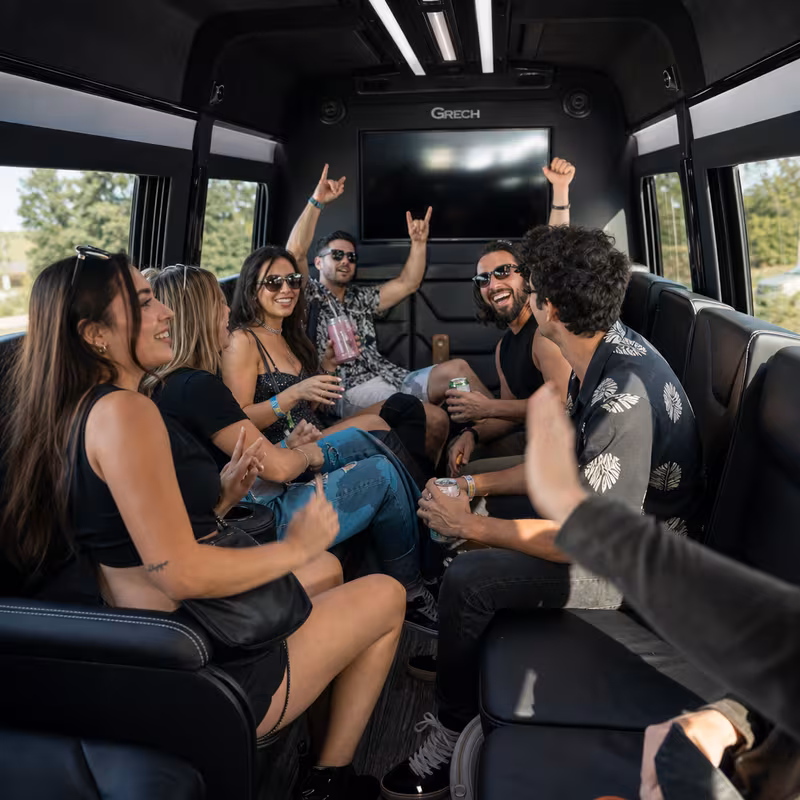 Group boarding a white charter bus for Concert Transportation transportation in Newark