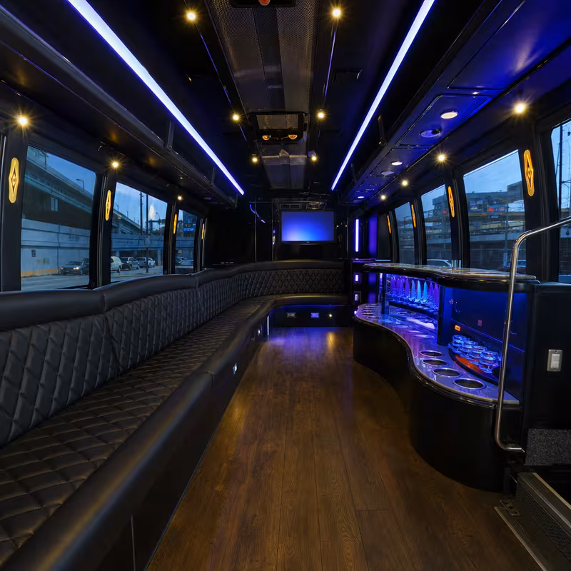 Party bus interior with wraparound leather seating and LED lighting in Newark