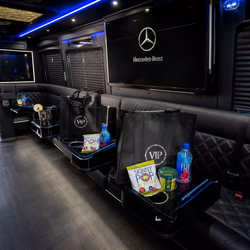 Party bus interior with wraparound leather seating and LED lighting in Newark